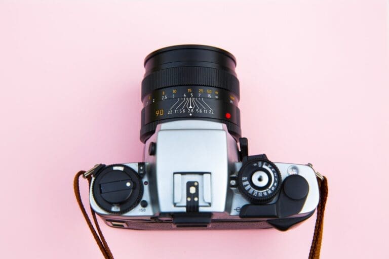 Black and Silver Camera on Brown Wooden Table